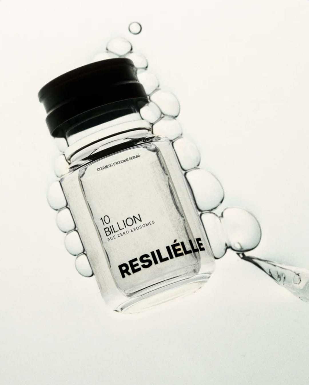 Cosmetic serum bottle labeled "10 Billion Resilielle" with bubbles against a light background.
